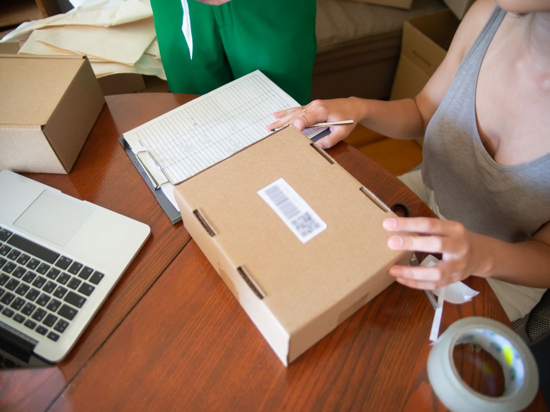 An e-commerce owner packing orders in a warehouse