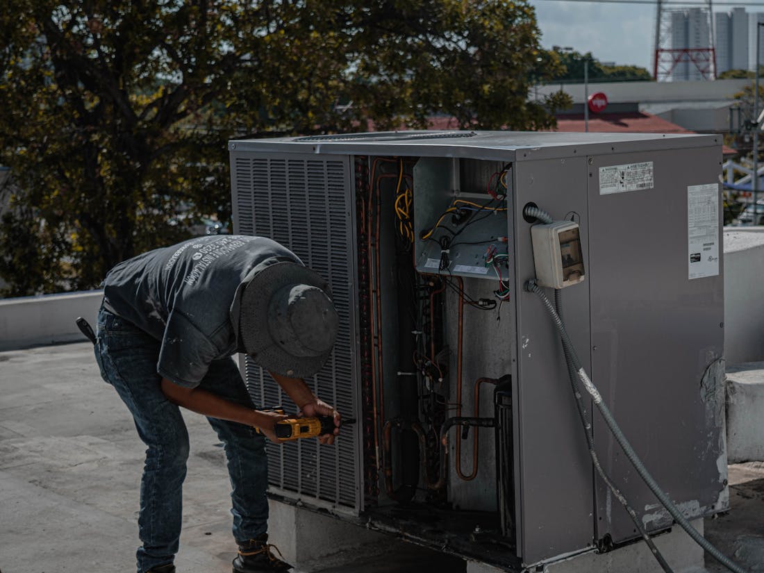 An HVAC technician servicing a unit